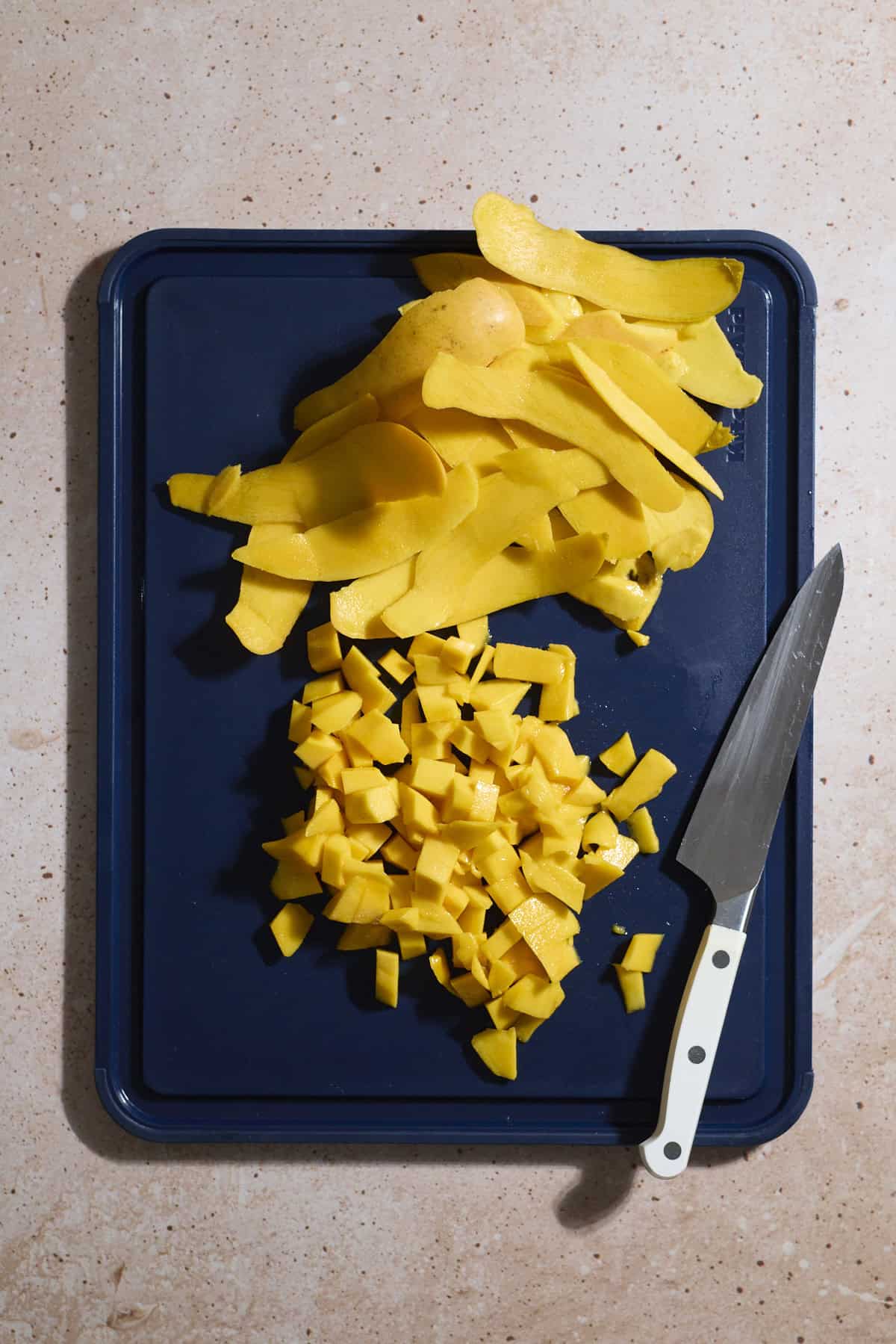Sliced mangos on a cutting board.