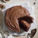 A Sourdough Chocolate Zucchini Cake with two slices leaning.