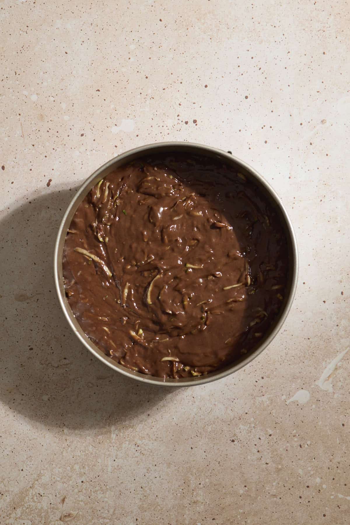 Cake batter spread into the baking pan.
