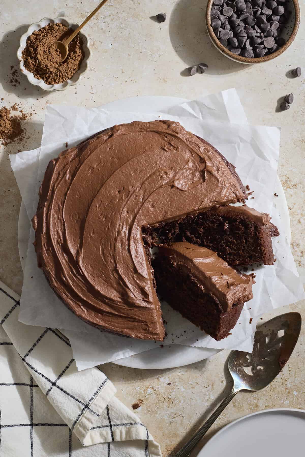 A Sourdough Chocolate Zucchini Cake with two slices leaning.
