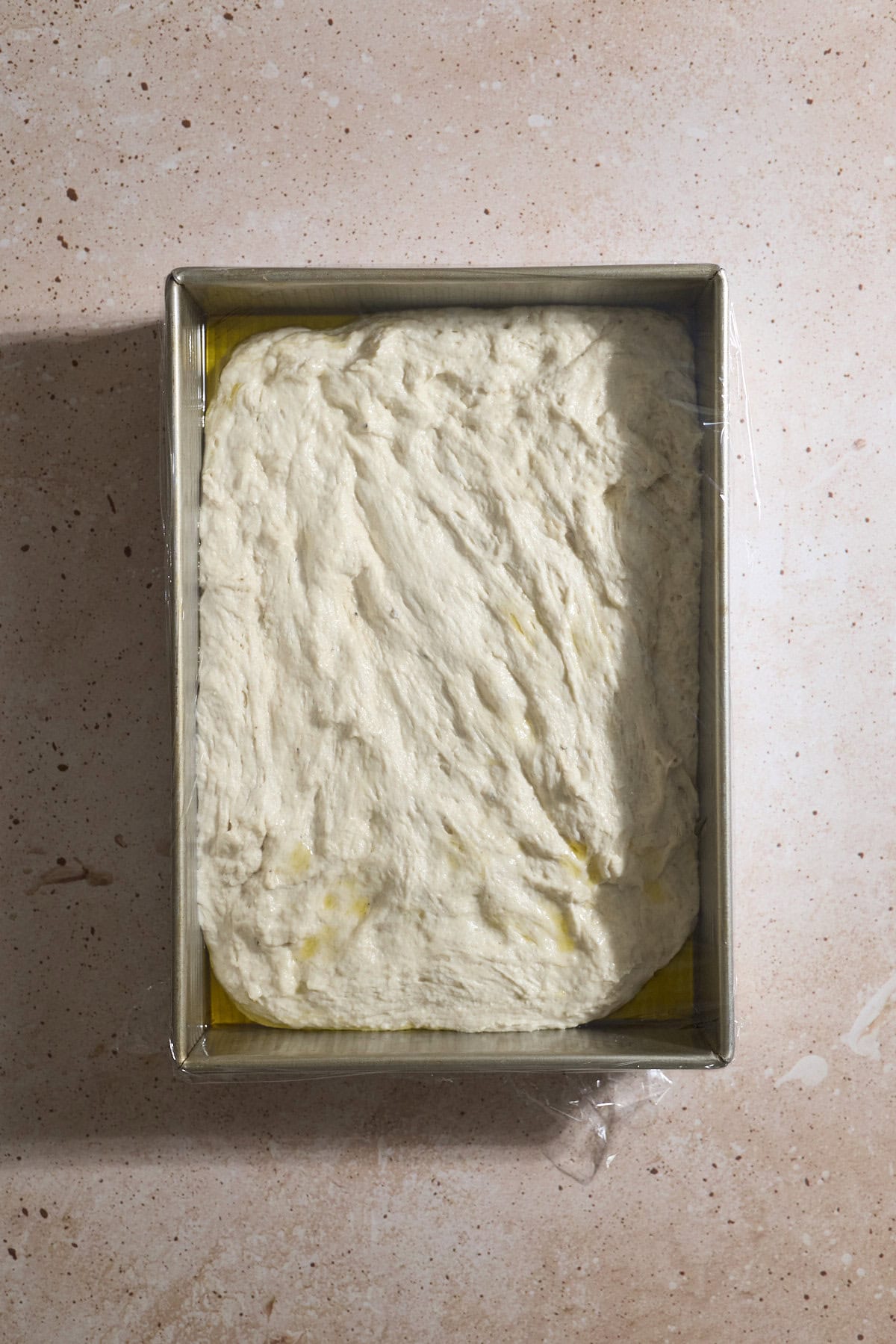 Dough spread to the edges in the baking pan.