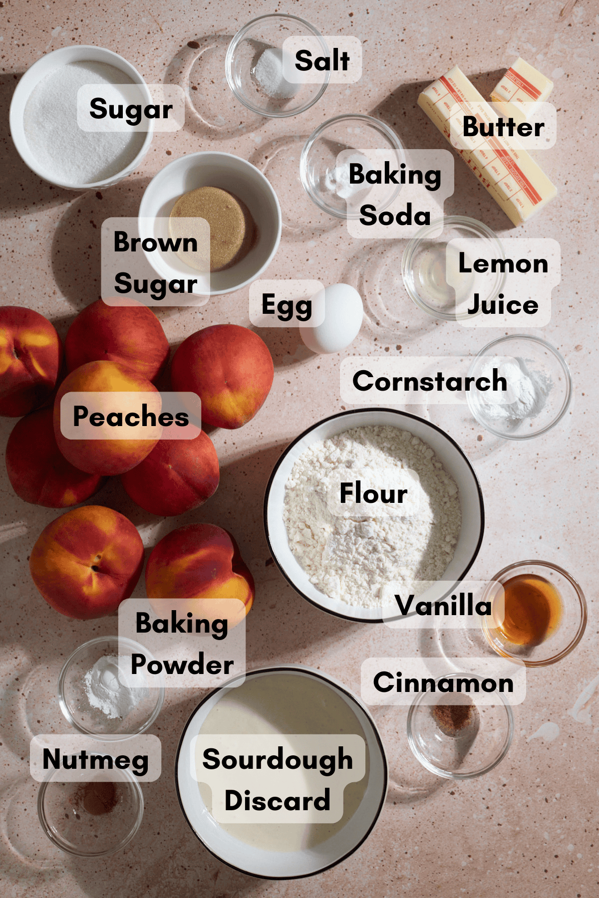 Ingredients for Sourdough Peach Cobbler in small bowls.