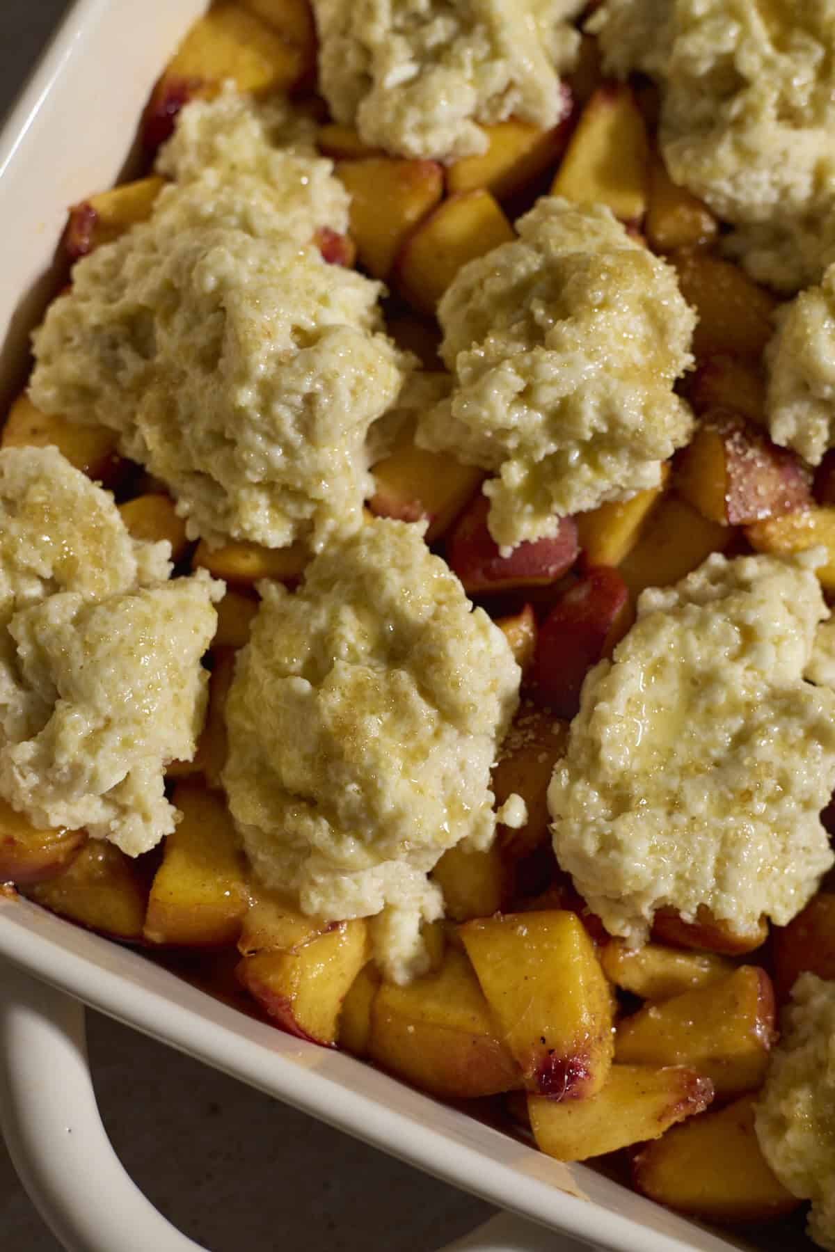 Topping on top of the chopped peaches.