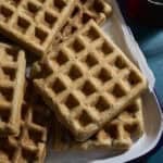A stack of Sourdough Zucchini Waffles on a white tray.