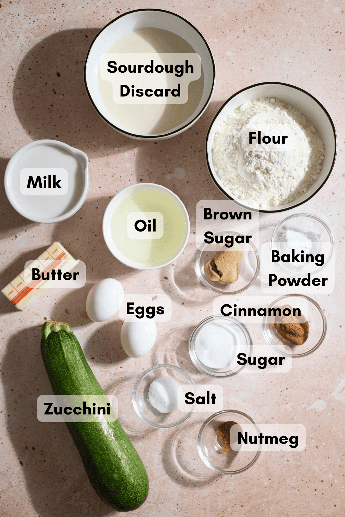 Ingredients for Sourdough Zucchini Waffles in small bowls.