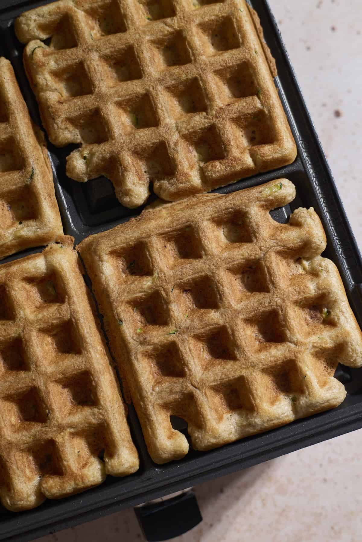 Waffles in the waffle iron after baking.