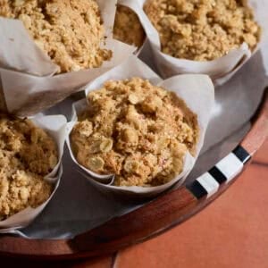 Sourdough Apple Muffins on a wooden tray.