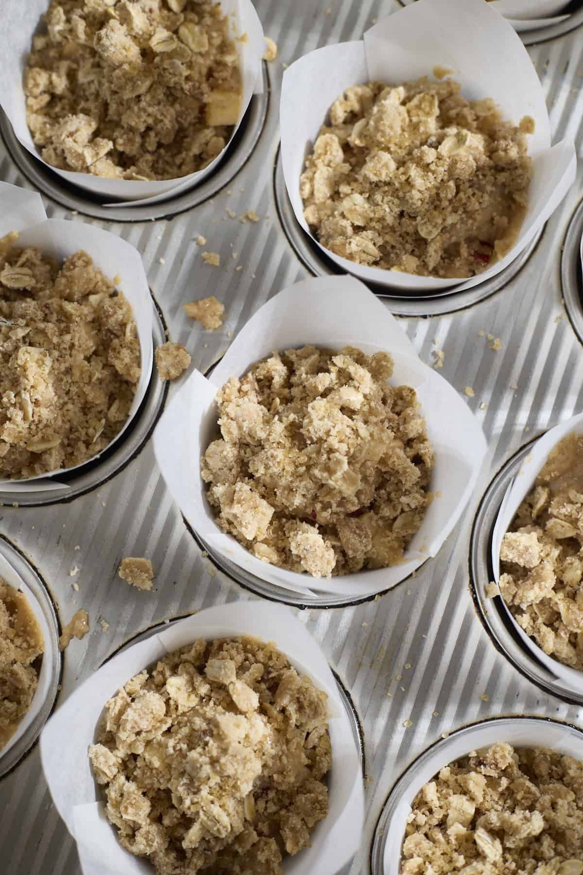Muffins with streusel topping in the baking pan.
