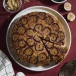 Sourdough Fig Cake on a white platter with a slice cut out.