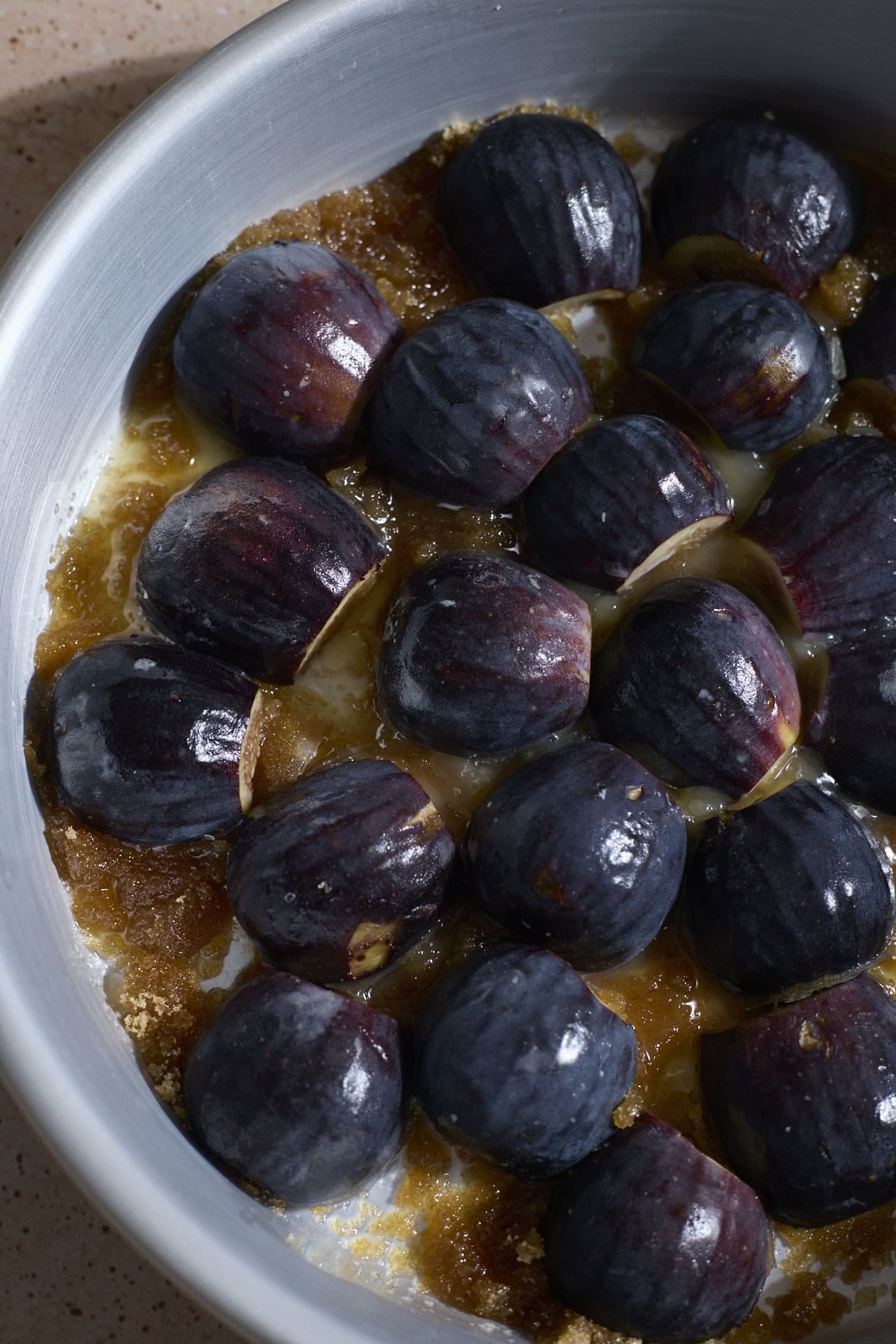 Figs and brown sugar in a layer in the bottom of the cake pan.