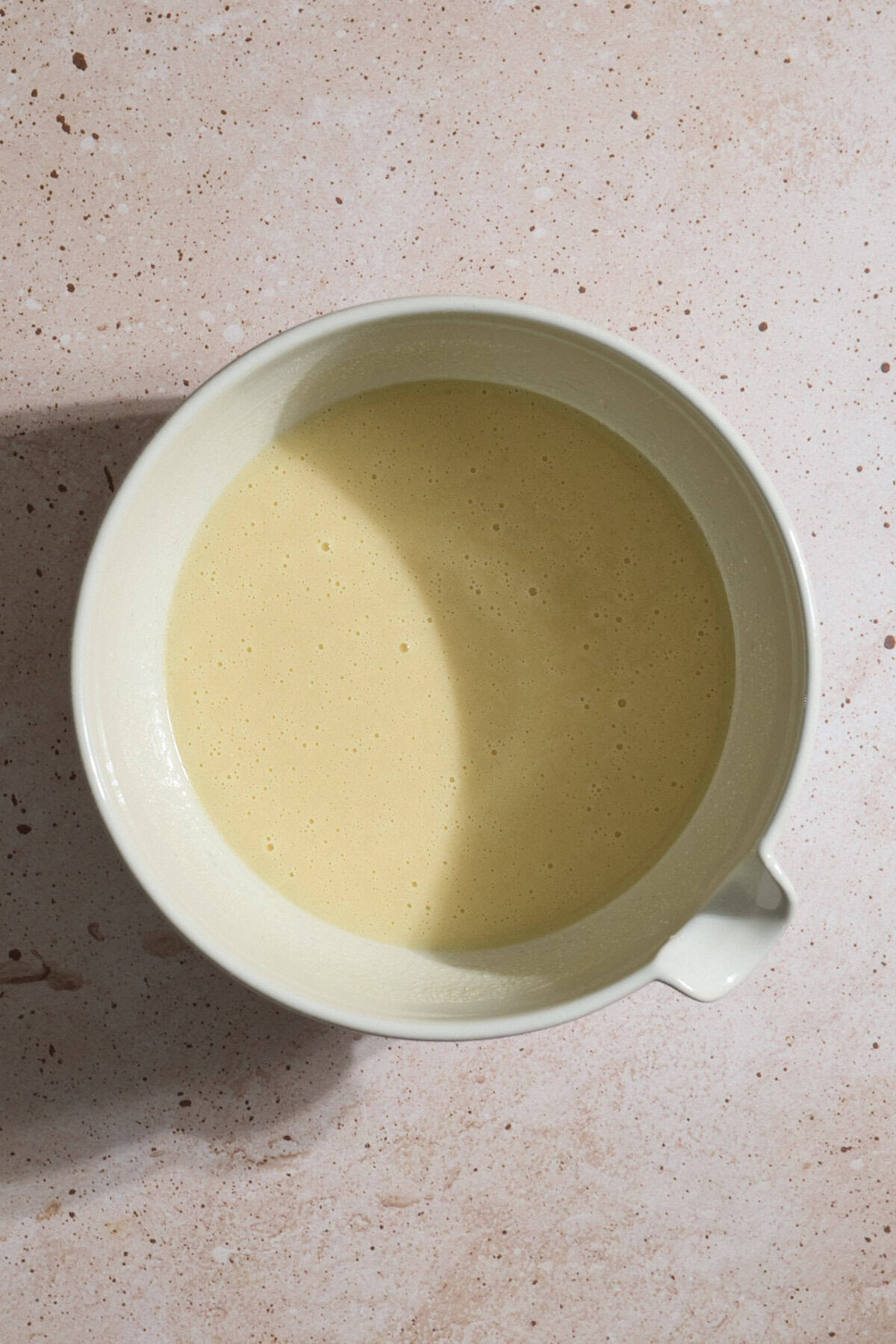 Wet ingredients mixed in a large mixing bowl.