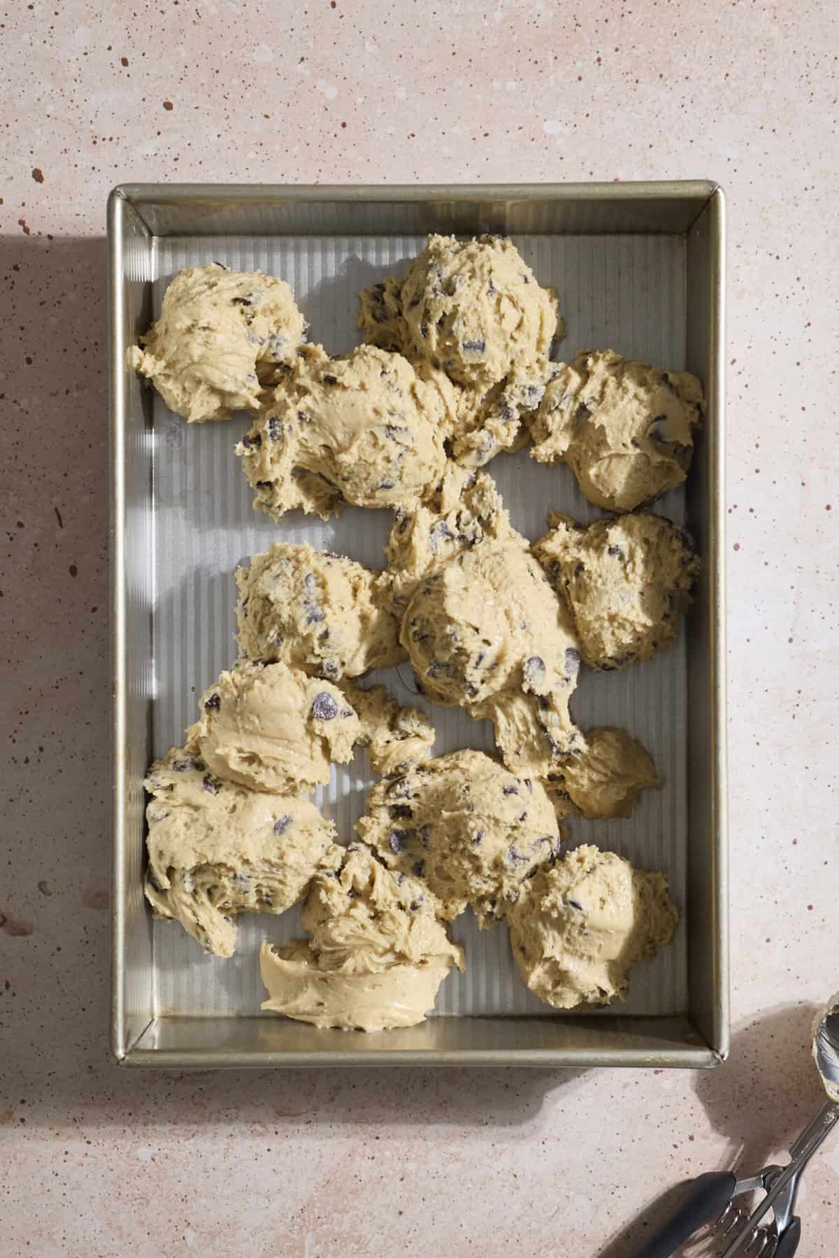 Cookie dough dropped into a 9x13-inch baking pan.