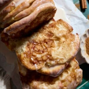 A piece of Sourdough Discard Apple Pull Apart Bread laying next to the loaf.