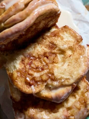 A piece of Sourdough Discard Apple Pull Apart Bread laying next to the loaf.