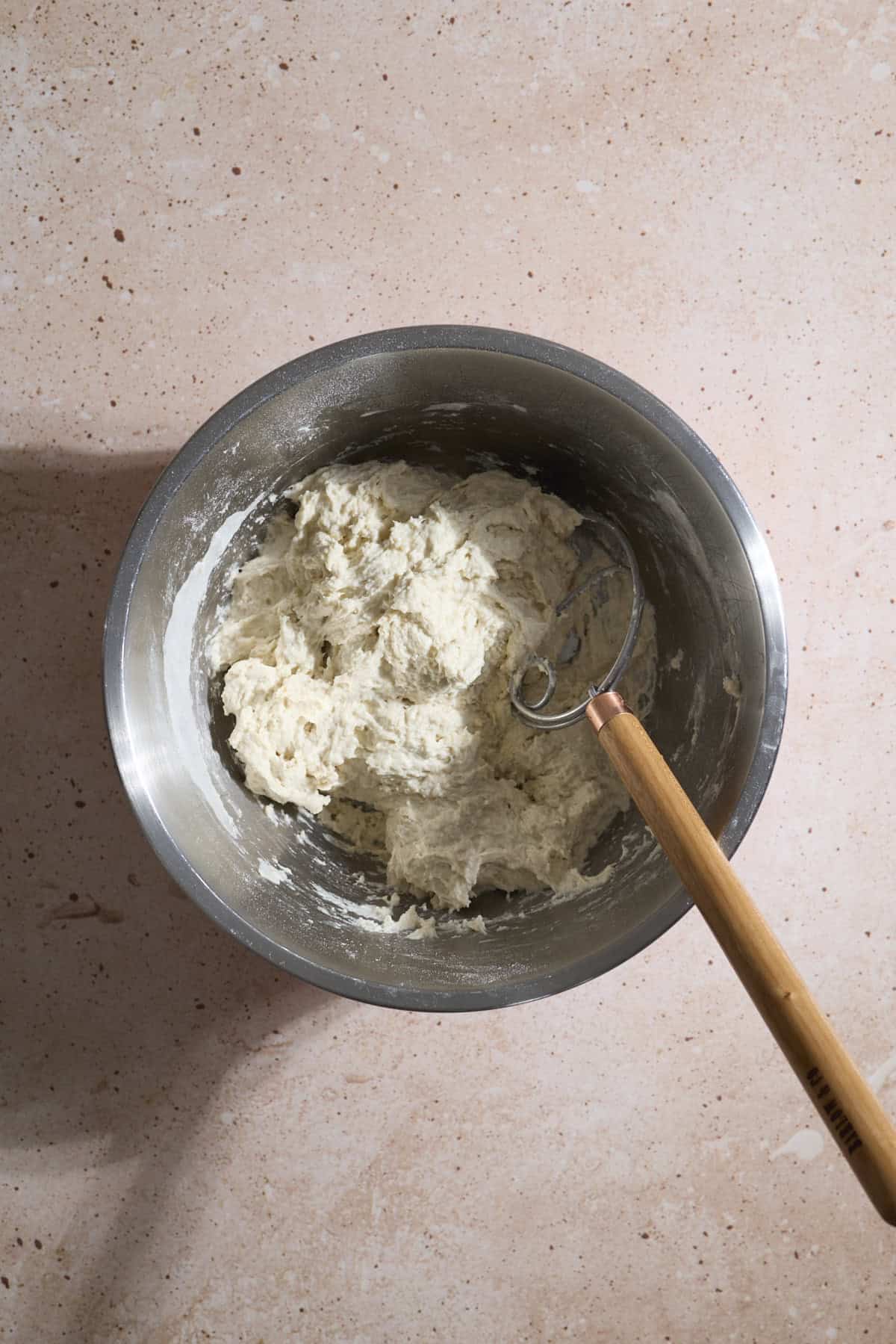 Dough mixed together in a mixing bowl.