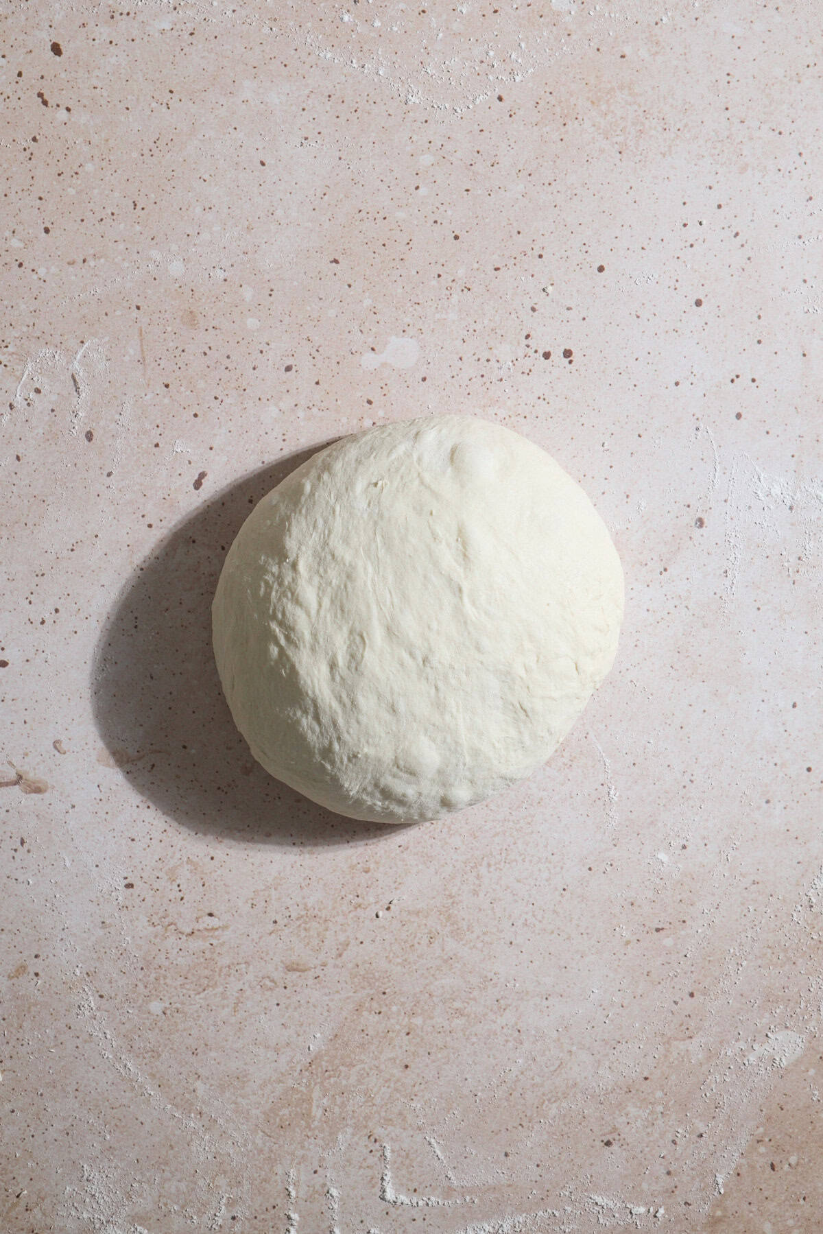 Dough formed into a taut ball.