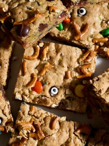 Sliced Sourdough Discard Halloween Kitchen Sink Cookie Bars in a pile.