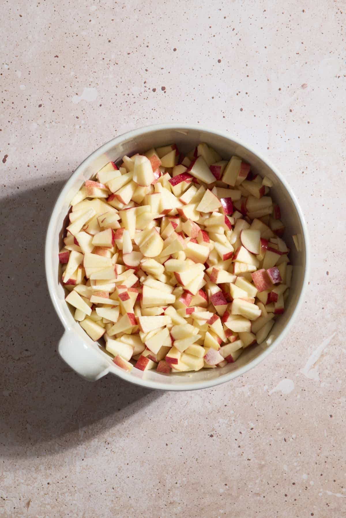 Diced apples in a large mixing bowl.