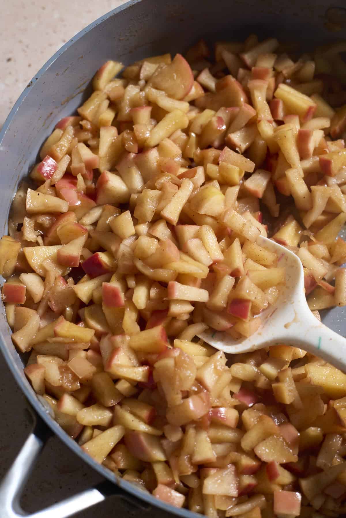 Apples cooking in a sautée pan.