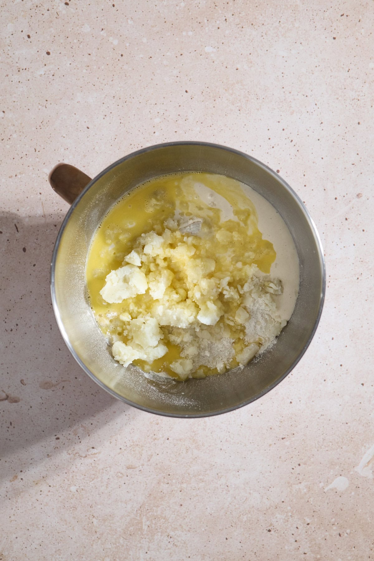 Dough ingredients in the bowl of a stand mixer.