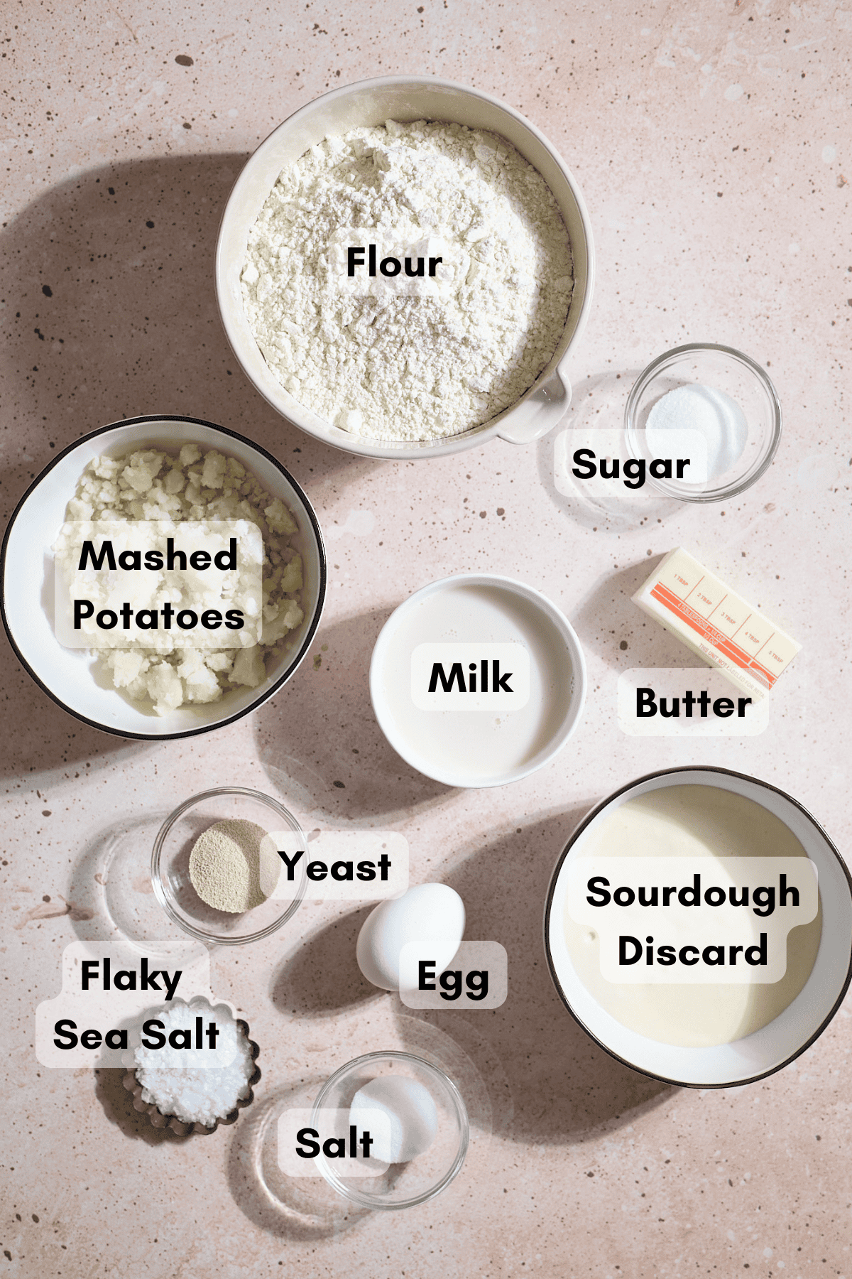 Ingredients for Sourdough Discard Potato Dinner Rolls in small bowls.