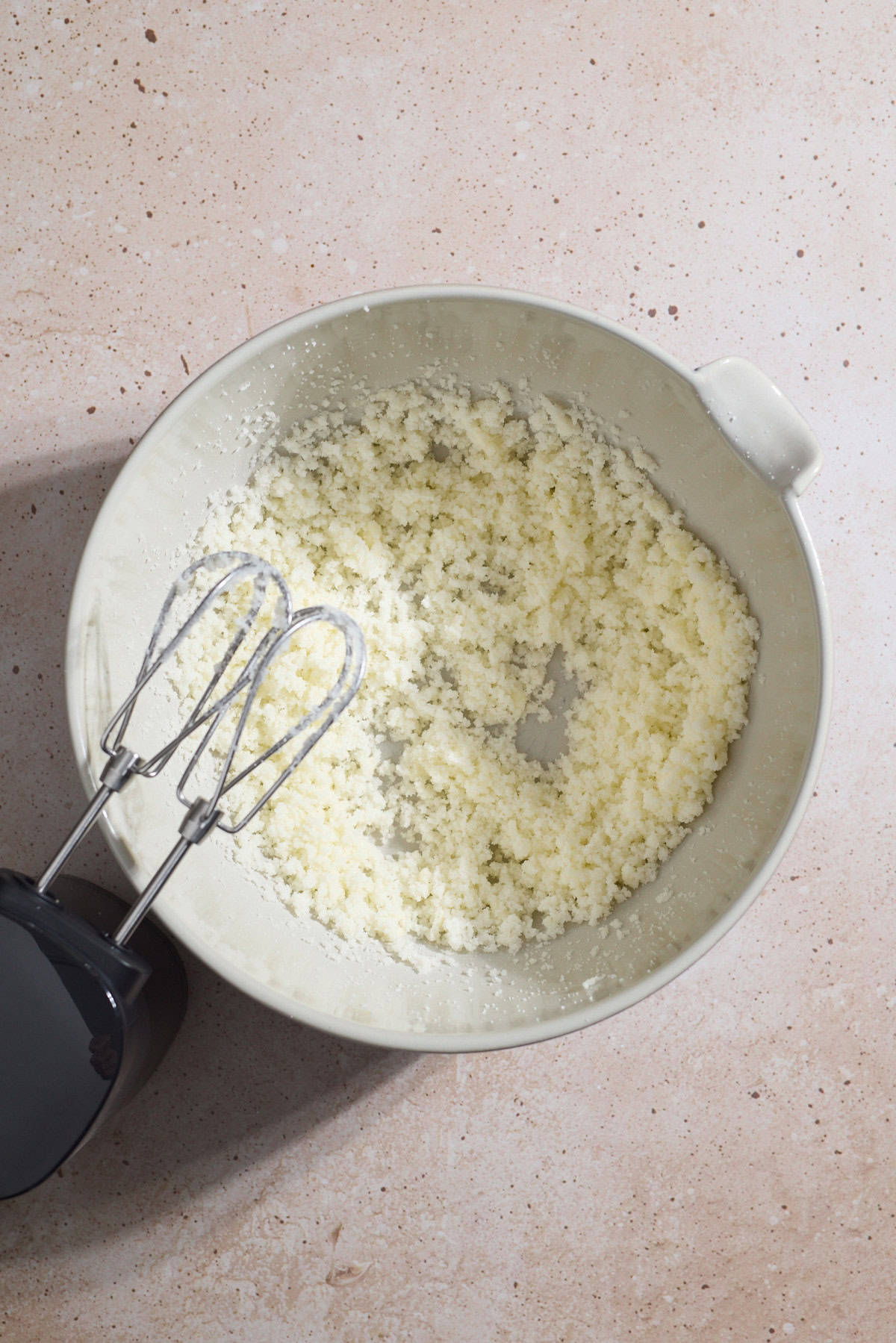 Butter and sugar creamed in a mixing bowl.