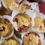 A pile of Sourdough Cranberry Orange Muffins on a tray.