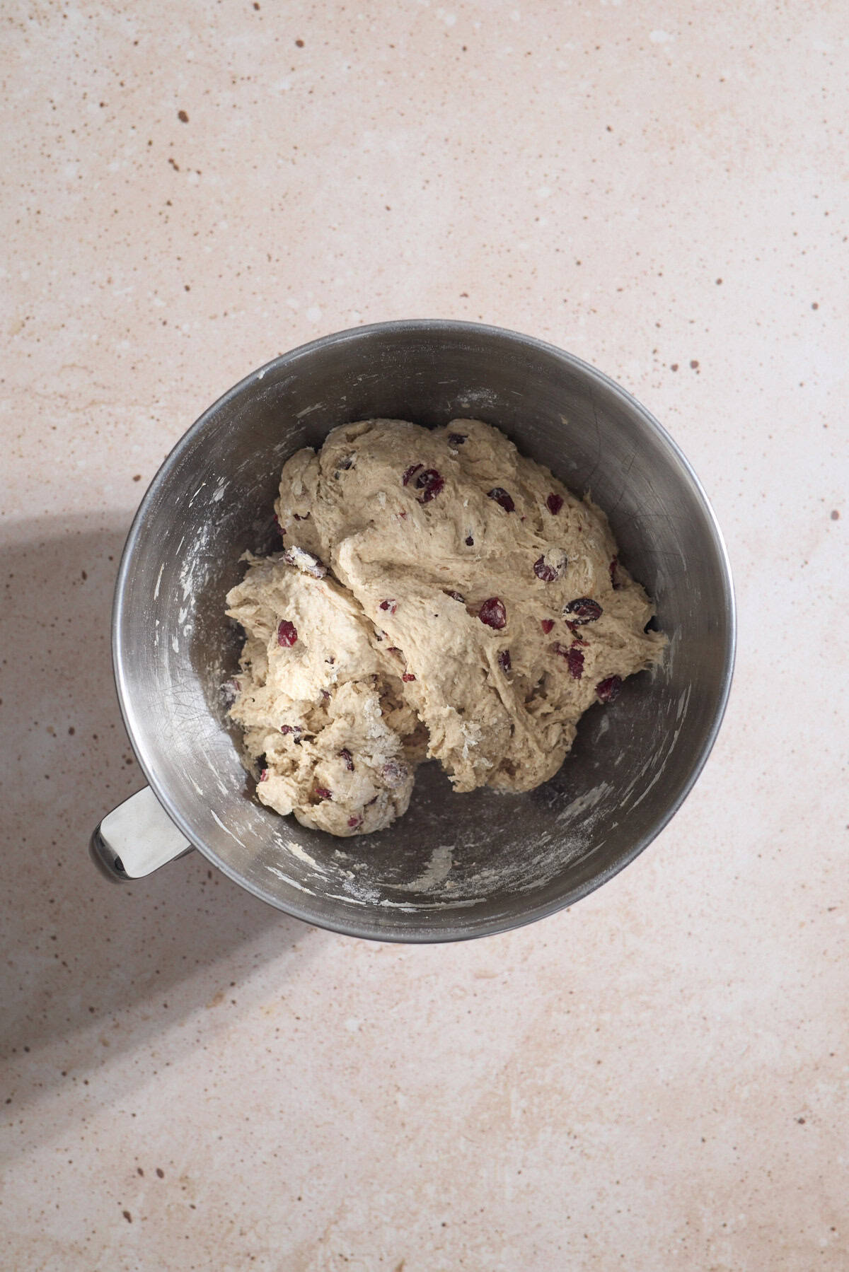 Dough mixed together in the bowl of a stand mixer.
