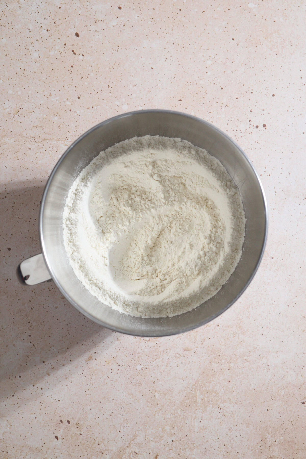 Dry ingredients mixed together in the bowl of a stand mixer.