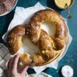 A Sourdough Discard Jumbo Pretzel on a white platter.
