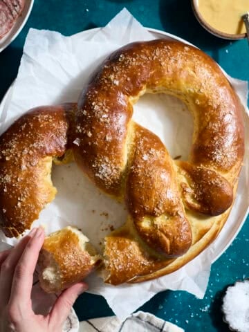 A Sourdough Discard Jumbo Pretzel on a white platter.