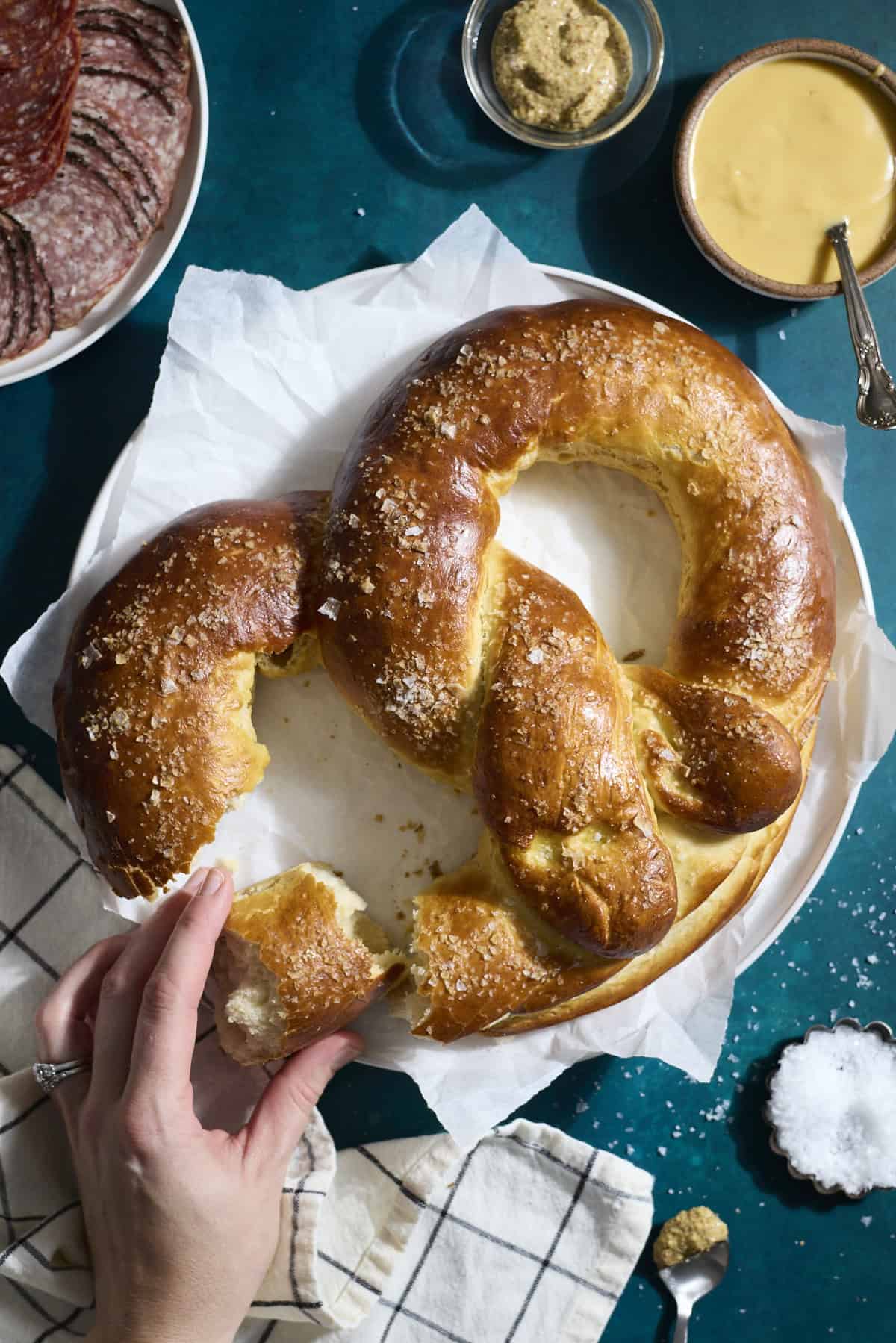 A Sourdough Discard Jumbo Pretzel on a white platter.