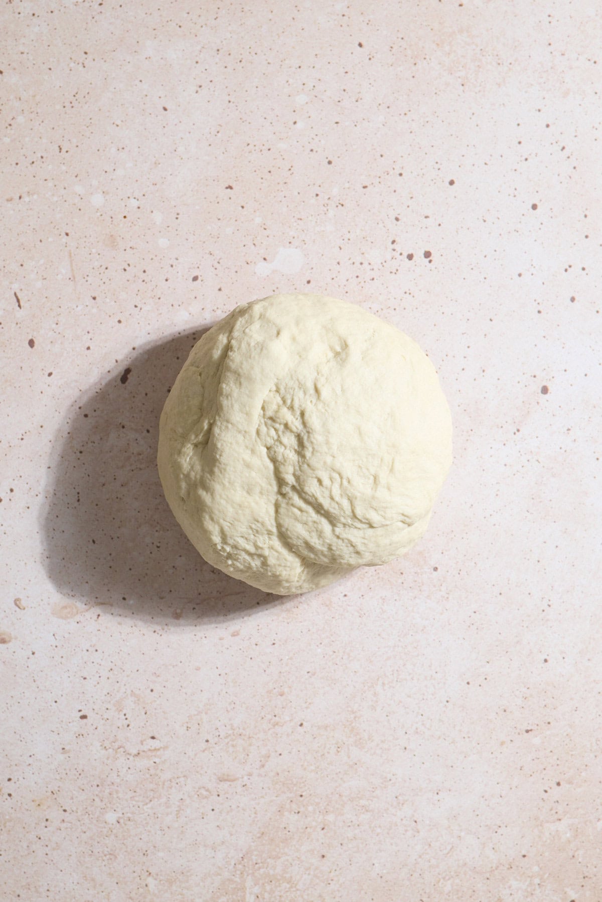 Smooth dough in a ball after kneading.