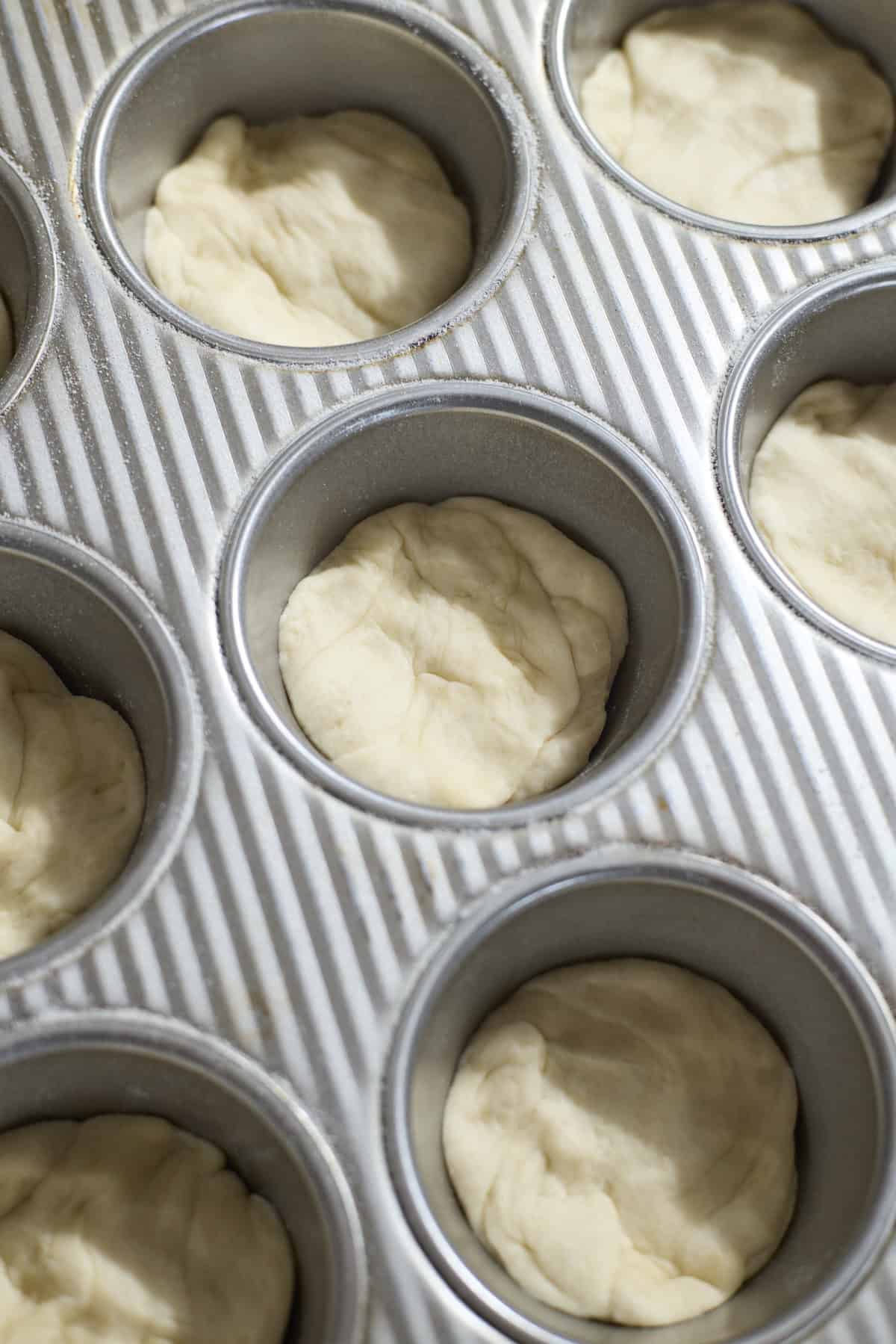 Dough pressed into the muffin pan.