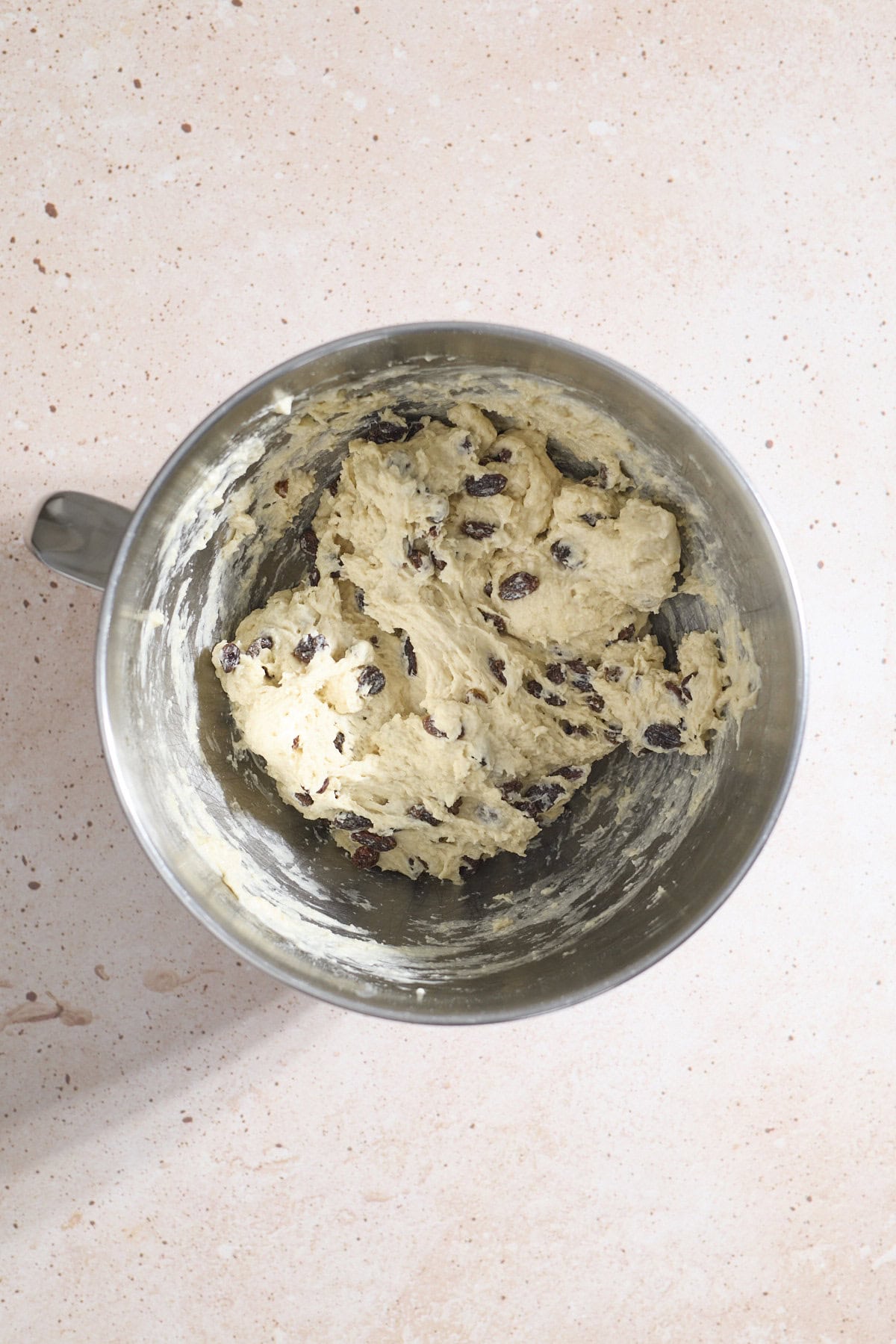 Shaggy dough in the bowl of a stand mixer.