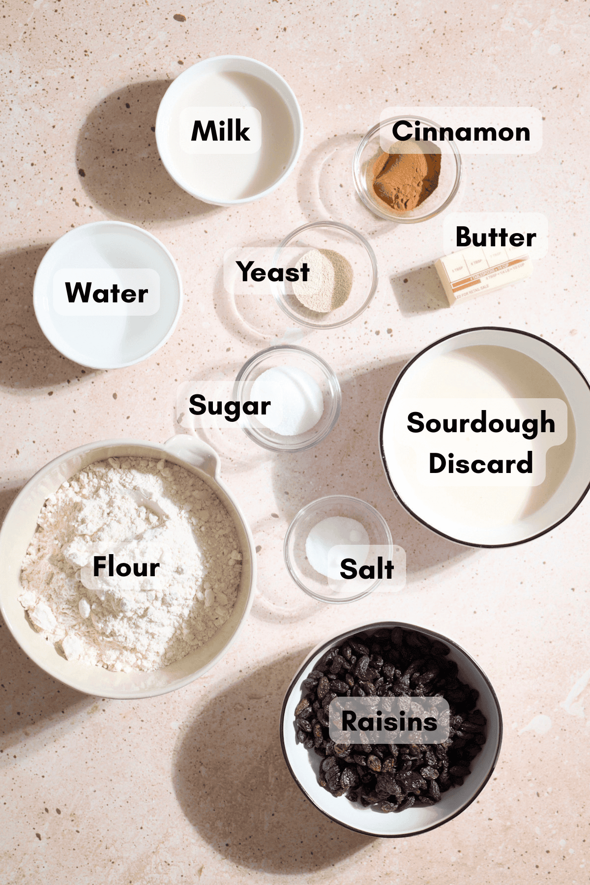 Ingredients for Sourdough Discard Cinnamon Raisin Bread in small bowls.