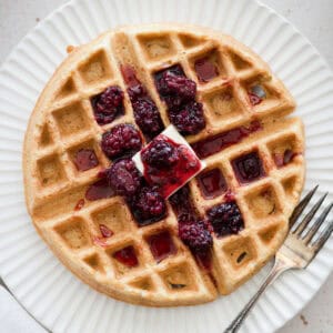 Cornmeal waffles topped with blackberry bourbon maple syrup.