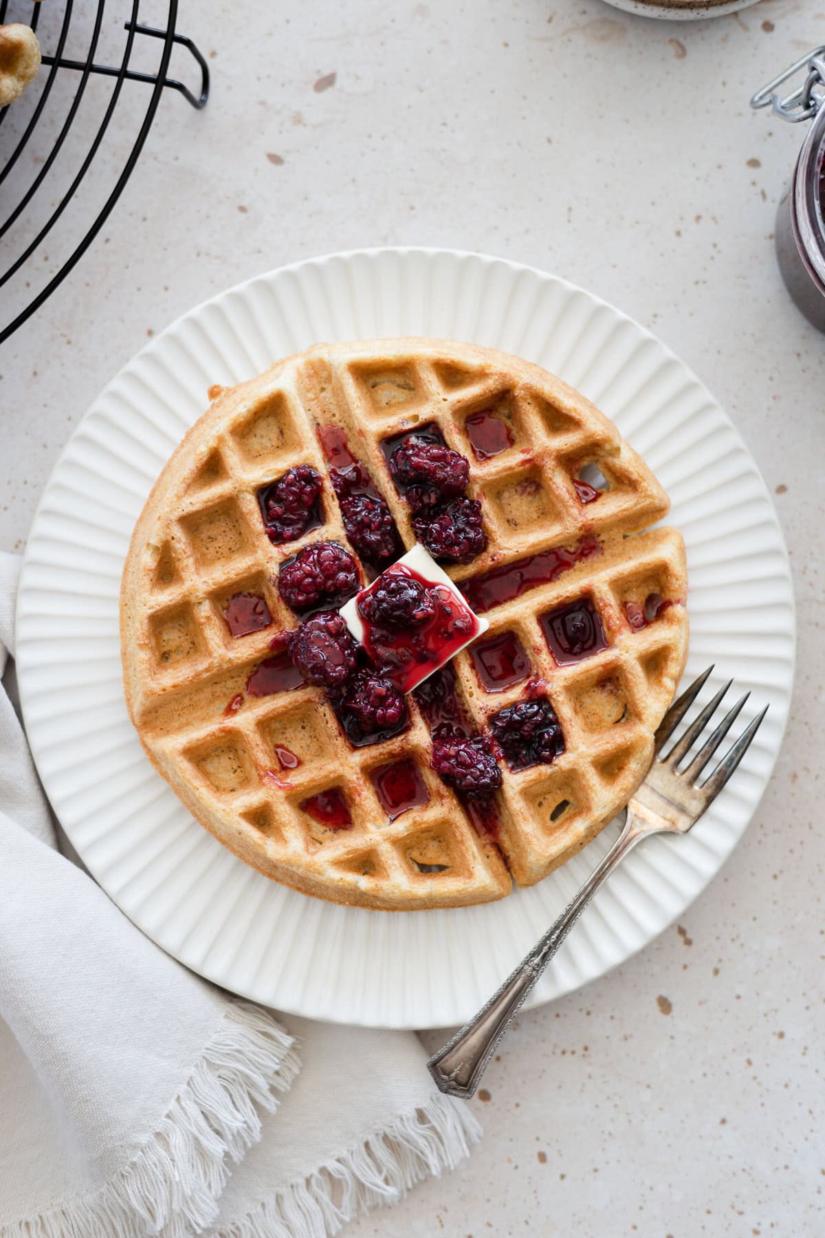 Cornmeal waffles topped with blackberry bourbon maple syrup.