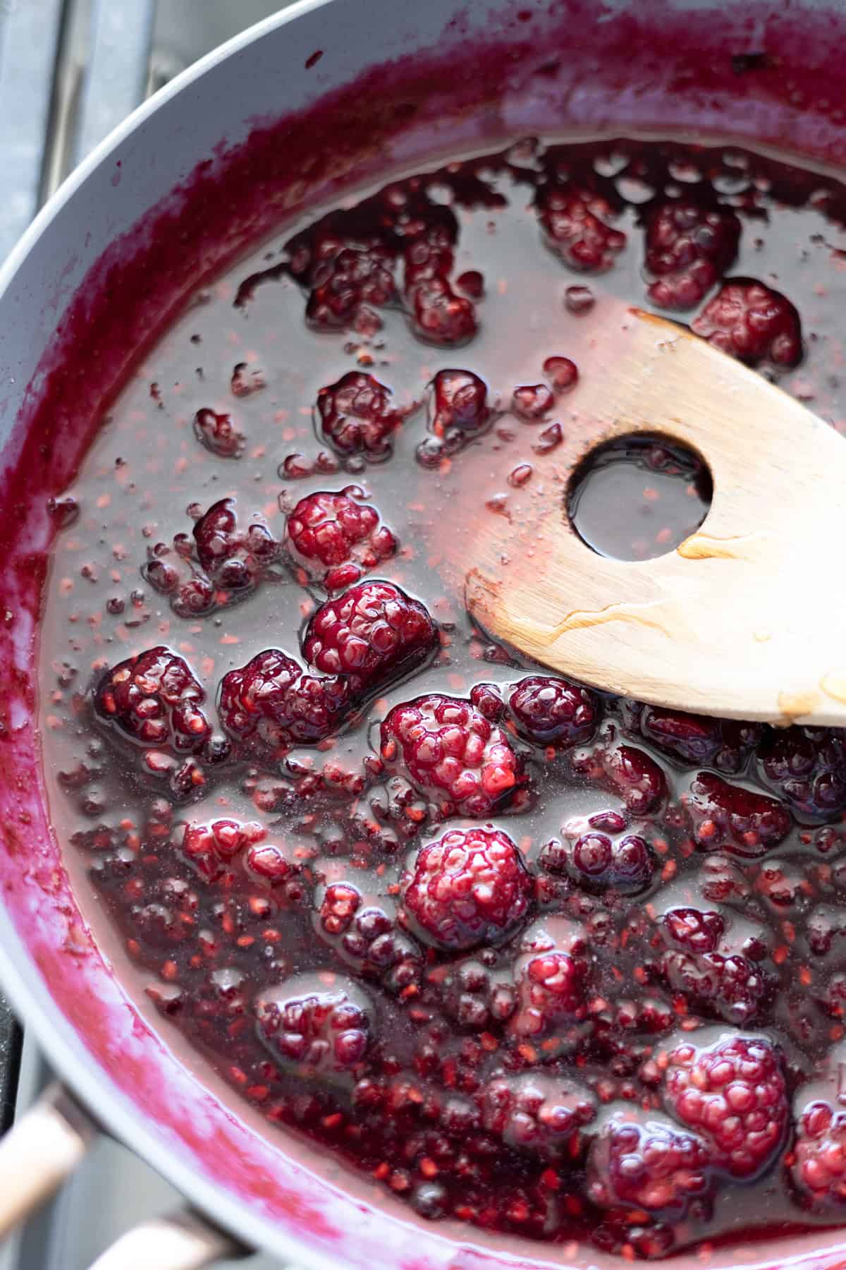 Blackberry bourbon maple syrup in a small skillet.