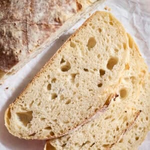 Slices of Sourdough Bread on a wooden cutting board.