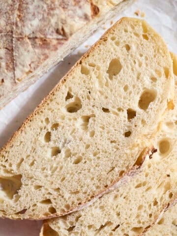 Slices of Sourdough Bread on a wooden cutting board.