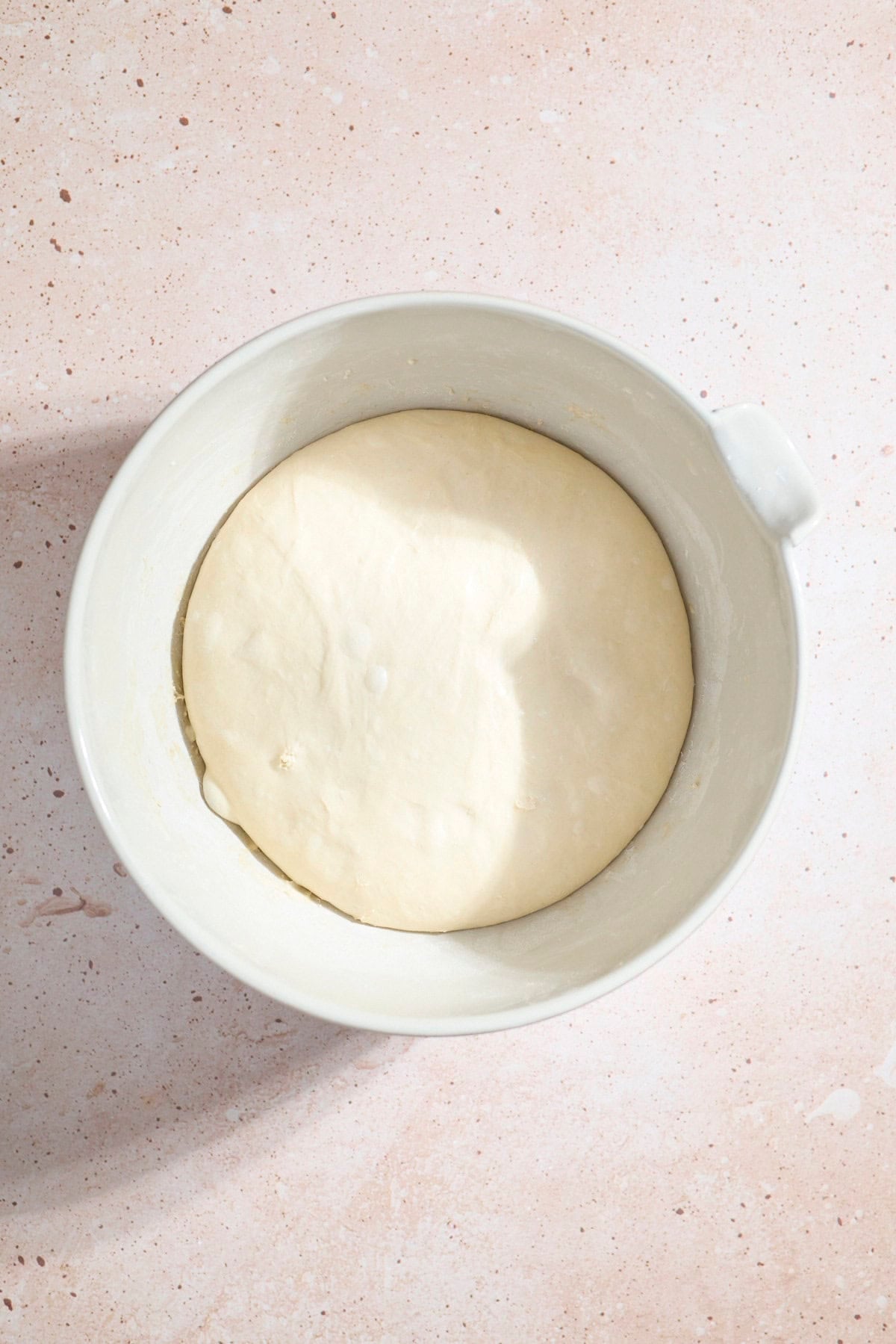 Dough after rising in a large bowl.