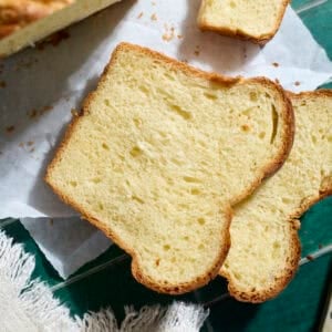 A slice of Sourdough Discard Brioche Bread on parchment paper.