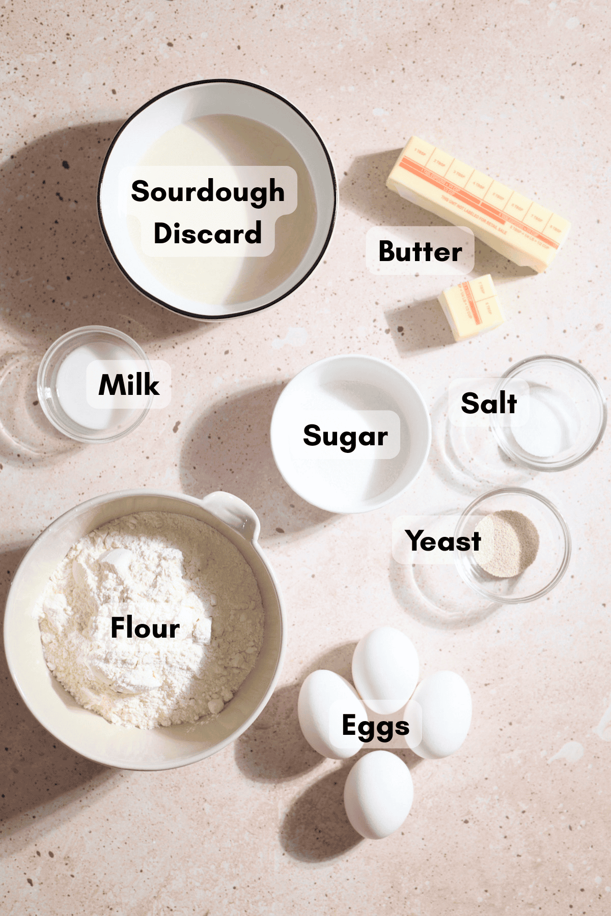 Ingredients for Sourdough Discard Brioche Bread in small bowls.