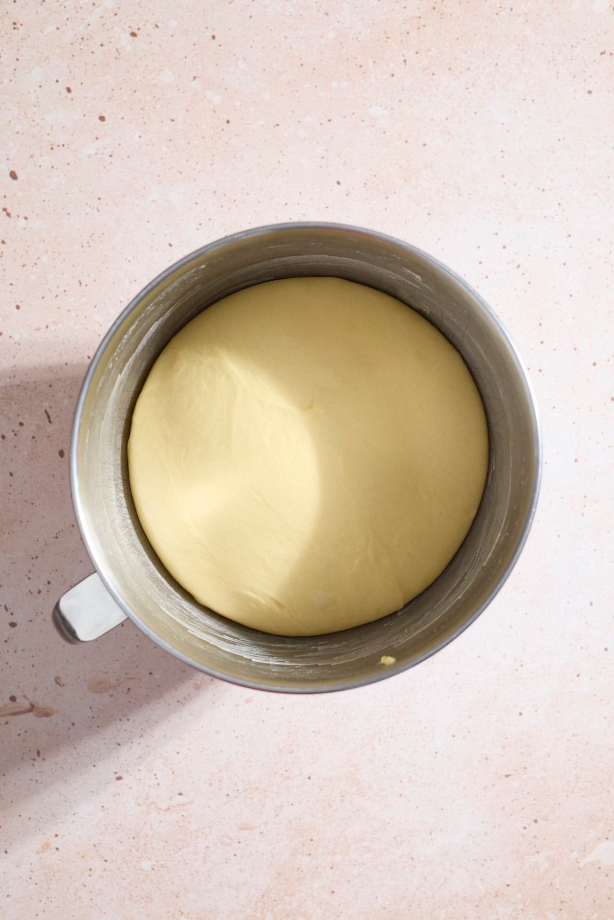 Smooth dough in the bowl after the first rise.