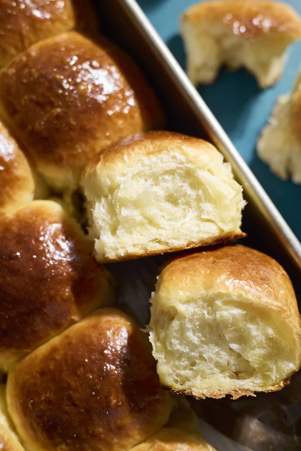 Sourdough Discard Brioche Rolls in a baking pan.