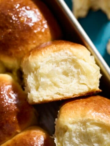 Sourdough Discard Brioche Rolls in a baking pan.