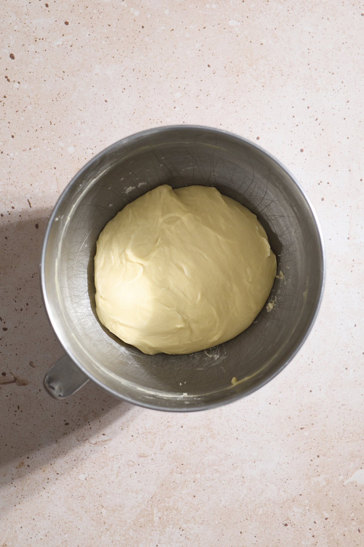 Smooth dough in a large bowl for rising.