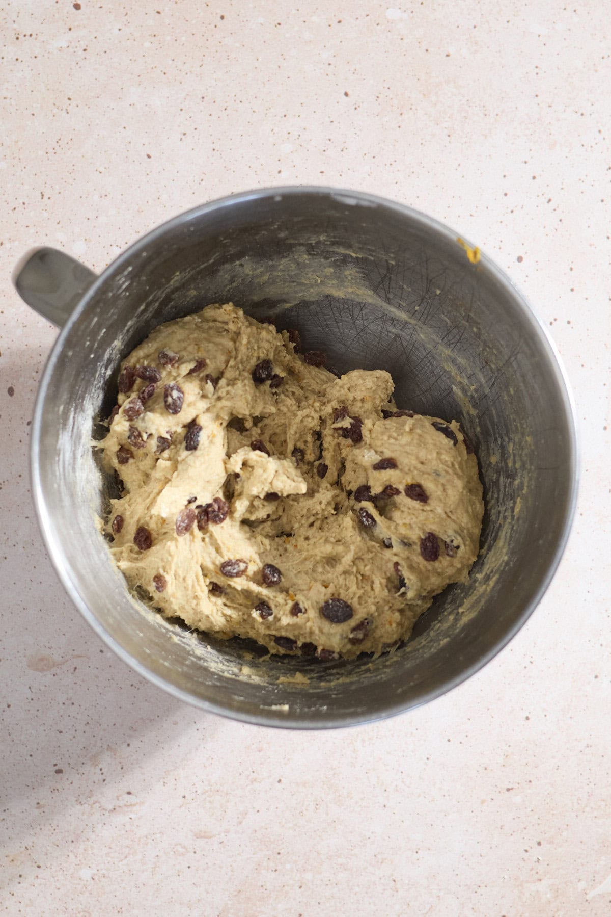 Shaggy dough in the bowl of a stand mixer.