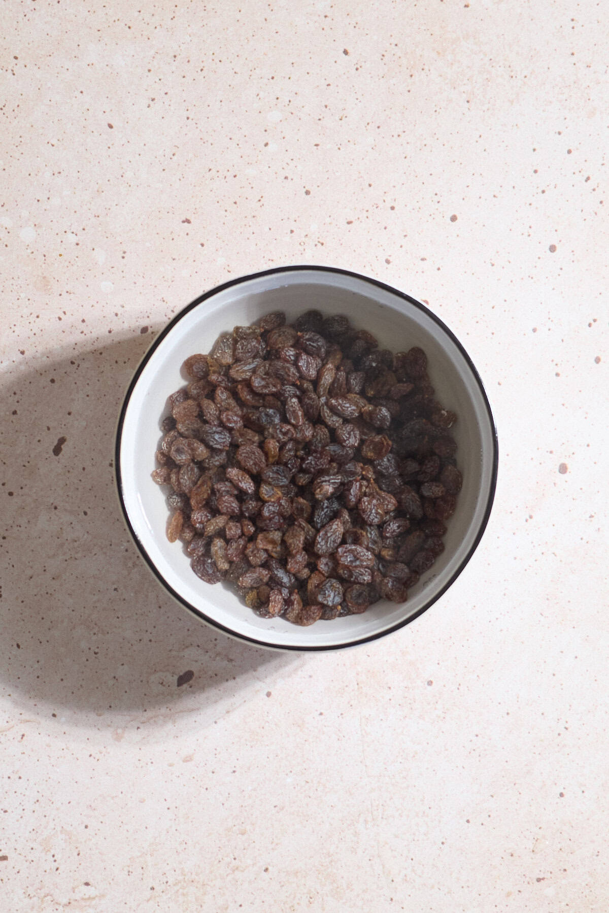 Raisins soaking in a bowl of water.